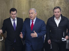 Israeli Prime Minister Benjamin Netanyahu arrives for the weekly cabinet meeting at his office in Jerusalem, Sunday, March 11, 2018.