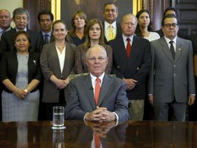 In this handout photo provided by the Peruvian Presidential Press Office, President Pedro Pablo Kuczynski poses with his cabinet before addressing the nation and announcing his resignation from office, Wednesday, March 21, 2018. The embattled Peruvian leader offered his resignation to Congress ahead of a scheduled vote on whether to impeach the former Wall Street investor, according to a presidential aide.