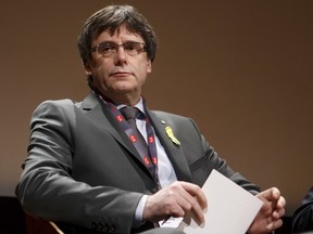 FILE - In this March 18, 2018 file photo Catalan's fugitive ex-president Carles Puigdemont, takes part in a panel titled "Self-Determination", at the International Film Festival and Forum on Human Rights, in Geneva, Switzerland. The lawyer for fugitive former Catalan leader Carles Puigdemont says that he is being held by German police. Jaume Alonso-Cuevillas has confirmed to The Associated Press that German police stopped Puigdemont on Sunday  March 25, 2018 when he was crossing the border from Denmark.
