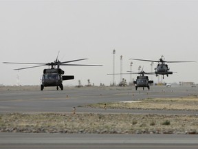 In this Monday, March 19, 2018 photo, UH-60 Black Hawk helicopters carrying US advisors and Afghan trainees take off from Kandahar Airfield, Afghanistan.
