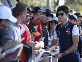 Williams driver Lance Stroll, right, of Canada meets fans as he arrives at the track at the Australian Formula One Grand Prix in Melbourne, Friday, March 23, 2018. The first race of the 2018 seasons is on Sunday.