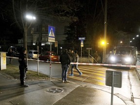 Police stand in front of the Iranian ambassador's residence after an attack in Vienna, Austria, Monday, March 12, 2018. Police say an Austrian attacker was shot and killed by the guard he wounded outside the residence.