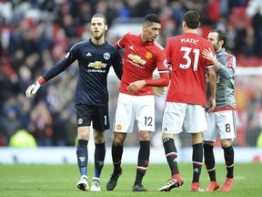 Manchester United's David De Gea, from left, Chris Smalling, Nemanja Matic, Juan Mata celebrate their victory during the English Premier League soccer match between Manchester United and Liverpool at Old Trafford in Manchester, England, Saturday, March 10, 2018.