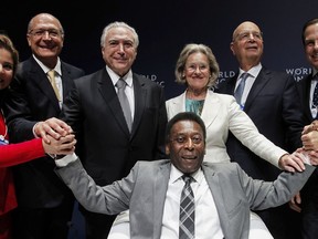 In this photo released by Brazil's presidential press office, Brazil's former soccer player Edson Arantes do Nascimento, better known as Pele, bottom, poses for a photo with, from left, World Economic Forum Senior Director for Latin America Marisol Argueta de Barillas, Sao Paulo Governor Geraldo Alckmin, Brazil's President Michel Temer, Chairperson and Co-Founder of the Schwab Foundation Hilde Schwab, Executive Chairman of the World Economic Forum Klaus Schwab, and Sao Paulo Mayor Joao Doria during the opening session of the World Economic Forum for Latin America, in Sao Paulo, Brazil, Wednesday, March 14, 2018. Pele received the Global Citizen Award during the forum.