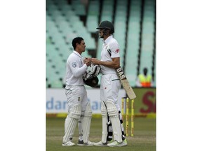 South Africa's batsman Quinton de Kock‚ left, shakes hand with teammate Morne Morkel at the end of the fifth and final day of the first cricket test match between South Africa and Australia at Kingsmead stadium in Durban, South Africa, Monday, March 5, 2018.
