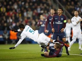PSG's Marco Verratti, bottom, stops Real Madrid's Varane during the round of 16, 2nd leg Champions League soccer match between Paris Saint-Germain and Real Madrid at the Parc des Princes Stadium in Paris, Tuesday, March 6, 2018.