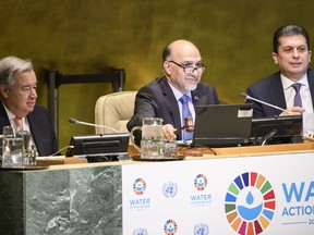 Afghanistan's United Nations ambassador Mahmoud Saikal, center, speaks in the General Assembly for the launch of the International Decade for Action on Water for Sustainable Development, Thursday, March 22, 2018, at U.N. headquarters. Sitting also are,  Secretary-General António Guterres, left, and Movses Abelian, right, an assistant secretary-general.