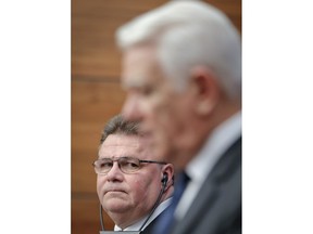 Lithuania's foreign minister Linas Linkevicius, left, looks at Romanian counterpart Teodor Melescanu during a joint press conference in Bucharest, Romania, Monday, March 26, 2018. Lithuania's foreign minister has strongly condemned the nerve agent attack on a spy in Britain, suggesting his country was poised to expel Russian diplomats in response.