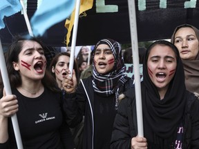 Migrants who live in Greece chant slogans during a rally against the EU-Turkey deal, in Athens, Saturday, March 17, 2018. About 2,000 protesters marched to the EU offices chanting against closed borders, but also against Turkish president Recep Tayyip Erdogan and Turkey's incursion into Syria, on a day when a boat that sank off a Greek island while smuggling migrants or refugees left at least 16 people dead.