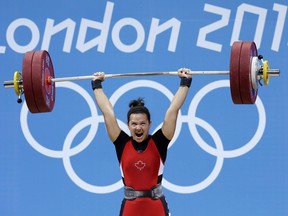 In this July 31, 2012 file photo, Christine Girard competes in women's 63-kg weightlifting at the London Olympics.