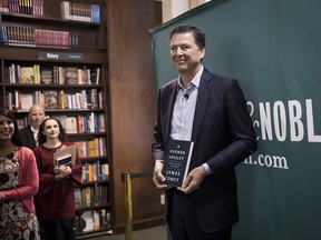 Former FBI Director James Comey poses for photographs as he arrives to speak about his new book "A Higher Loyalty: Truth, Lies, and Leadership" at Barnes & Noble bookstore, April 18, 2018 in New York City.