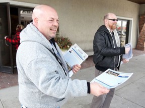 Unifor Local 444 union reps Mark Dufour, left, and George Shyduke hand out a report of a tentative agreement with Caesars Windsor during a ratification vote at the Fogolar Furlan Club. NICK BRANCACCIO