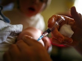 A young boy receives an immunization jab at a health centre in Glasgow, Scotland on Sept. 3, 2007.