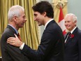 Canadian Prime Minister Justin Trudeau speaks with his Minister of Foreign Affairs Stephane Dion during a swearing-in ceremony at Rideau Hall in Ottawa on  November 4, 2015.