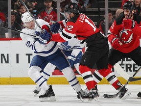 Patrick Marleau of the Toronto Maple Leafs and the Devils' Ben Lovejoy battle during the third period Thursday night at the Prudential Center in Newark, N.J. The Devils beat the Leafs 2-1 and clinched a playoff berth in the 2018 Stanley Cup playoffs.