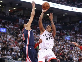 DeMar DeRozan of the Raptors shoots and scores a basket over Otto Porter Jr. of the Washington Wizards in the third quarter during Game 1 of their NBA Eastern Conference first-round playoff series on Saturday night at the Air Canada Centre in Toronto.