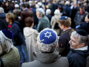 Participants wearing a kippah during a "wear a kippah" gathering to protest against anti-Semitism in front of the Jewish Community House on April 25, 2018 in Berlin, Germany.
