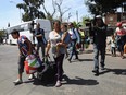 Central American asylum seekers arrive by bus at an immigrant shelter on April 25, 2018 in Tijuana, Mexico.