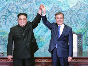 North Korean leader Kim Jong Un (L) and South Korean President Moon Jae-in (R) pose for photographs after signing the Panmunjom Declaration for Peace, Prosperity and Unification of the Korean Peninsula during the Inter-Korean Summit at the Peace House on April 27, 2018 in Panmunjom, South Korea.