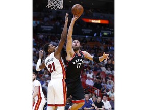 Toronto Raptors center Jonas Valanciunas (17) goes up for a shot against Miami Heat center Hassan Whiteside (21) during the first half of an NBA basketball game Wednesday, April 11, 2018, in Miami.