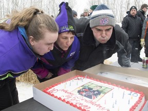 ADDS PHOTOGRAPHER'S SURNAME Humboldt Broncos' Adam Herold's father Russell, mother Raelene and sister Erin blow out the 17 candles on his birthday cake as family and friends celebrate what would have been Adam's 17th birthday in Montmartre, Sask. on Thursday, April 12, 2018.