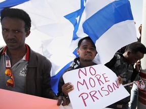 African migrants protest outside the Saharonim Prison, an Israeli detention facility for African asylum seekers near Kziot, where at least nine others have been incarcerated as part of Israel's new policy of prison or deportation for migrants, in Israel's southern Negev desert near the Egyptian border on February 22, 2018.
