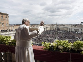 In this handout picture released by the Vatican press office Pope Francis delivers the "Urbi et Orbi" blessing to the city and to the world from the balcony of St Peter's basilica after the Easter Sunday Mass on April 1, 2018 in Vatican.