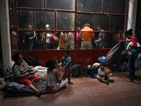 Central American migrants taking part in a caravan called 'Migrant Viacrucis' rest at a sports centre field in Matias Romero, Oaxaca state, Mexico on April 2, 2018.