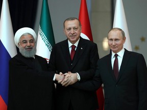 Turkish President Recep Tayyip Erdogan (centre), Russian President Vladimir Putin (right) and President of Iran, Hassan Rouhani (left) pose for a photo ahead of the Turkey-Russia-Iran Tripartite summit in Ankara, Turkey on April 04, 2018.