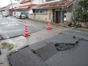 This photo released by the Shimane Nichinichi Shimbun via Jiji Press on April 9, 2018 shows the tarmac along a street damaged by a earthquake in the city of Oda, Shimane prefecture.