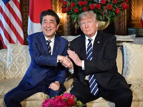 Donald Trump greets Japanese Prime Minister Shinzo Abe as he arrives for talks at Trump's Mar-a-Lago resort in Palm Beach, Florida, on April 17, 2018.