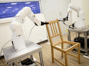 Autonomous robotic arms assembling an IKEA chair in Singapore.