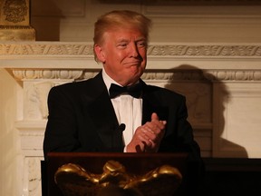 U.S. President Donald Trump applauds during the State Dinner for French President Emmanuel Macron at the White House in Washington, DC, April 24, 2018.