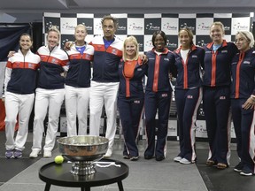 From left, France's Team members Amandine Hesse, Pauline Parmentier, Kristina Mladenovic, captain Yannick Noah and United States' Fed Cup team members, captain Kathy Rinaldi, Sloane Stephens, Madison Keys, Coco Vandeweghe, Bethanie Mattek-Sands, pose for photo after the draw ceremony in Aix-en-Provence, Friday, April 20, 2018. The Fed Cup semifinal matches between France and USA will take place Saturday and next Sunday.