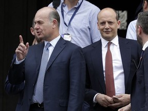 AS Roma CEO Umberto Gandini, left, and General Director Mauro Baldissoni, right, leave the Interior Ministry headquarters in Rome, Friday, April 27, 2018. Officials from Roma, Liverpool and UEFA met in Rome to discuss security concerns ahead of their Champions League return match next week.