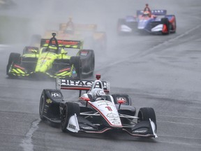 IndyCar driver Josef Newgarden (1) leads a pack of cars during the Honda Indy Grand Prix of Alabama auto race at Barber Motorsports Park, Sunday, April 22, 2018, in Birmingham, Ala. Race is postponed until Monday due to weather.