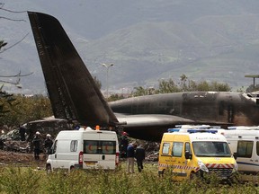 Firefighters and civil security officers work at the scene of a fatal military plane crash in Boufarik, near the Algerian capital, Algiers, Wednesday, April 11, 2018.