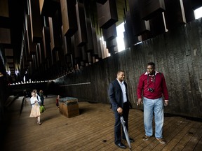 Visitors walk through EJI's National Memorial for Peace and Justice in Montgomery, Ala., on Thursday, April 26, 2018. The memorial opened Thursday, commemorating 4,400 black people who were slain in lynchings and other racial killings between 1877 and 1950.