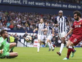 Liverpool's Mohamed Salah scores his side's second goal of the game, during the English Premier League soccer match between West Bromwich Albion and Liverpool, at The Hawthorns, West Bromwich, England, Saturday April 21, 2018.