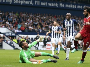 Liverpool's Mohamed Salah scores his side's second goal of the game, during the English Premier League soccer match between West Bromwich Albion and Liverpool, at The Hawthorns, West Bromwich, England, Saturday April 21, 2018.