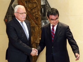 Palestinian Foreign Minister Riyad al-Maliki, left, shakes hands with Japan's Foreign Minister Taro Kono before a meeting on the "Corridor for Peace and Prosperity," at Dead Sea, Jordan, Sunday, April 29, 2018.