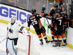 Members of the Anaheim Ducks celebrate Jakob Silfverberg's goal past San Jose Sharks goaltender Martin Jones during the first period of Game 2 of an NHL hockey first-round playoff series in Anaheim, Calif., Saturday, April 14, 2018.