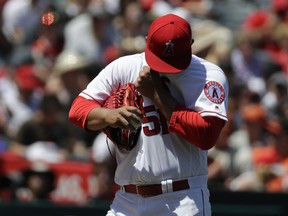 Los Angeles Angels starting pitcher Jaime Barria wipes his face during the first inning of a baseball game against the San Francisco Giants in Anaheim, Calif., Sunday, April 22, 2018.