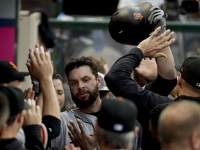 San Francisco Giants' Brandon Belt celebrates in the dugout after his two-run home run against the Los Angeles Angels during the second inning of a baseball game in Anaheim, Calif., Saturday, April 21, 2018.