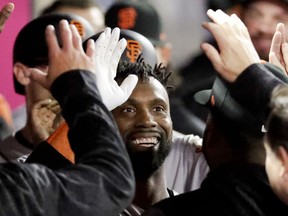 San Francisco Giants' Andrew McCutchen celebrates in the dugout after his three-run home run against the Los Angeles Angels during the fifth inning of a baseball game in Anaheim, Calif., Friday, April 20, 2018.