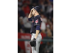 Cleveland Indians relief pitcher Dan Otero wipes his face after giving up a two-RBI double against Los Angeles Angels' Rene Rivera during the fifth inning of a baseball game, Tuesday, April 3, 2018, in Anaheim, Calif.