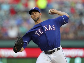 Texas Rangers starting pitcher Mike Minor (36) works the first inning of a baseball game against the Seattle Mariners on Friday, April 20, 2018, in Arlington, Texas.