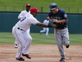 Texas Rangers third baseman Adrian Beltre (29) tags out Seattle Mariners' Ben Gamel, right, to end the second inning of a baseball game Sunday, April 22, 2018, in Arlington, Texas.