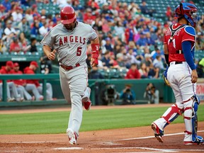 Los Angeles Angels' Albert Pujols (5) scores on a single by Jefry Marte during the first inning of a baseball game against the Texas Rangers in Arlington, Texas, Tuesday, April 10, 2018.