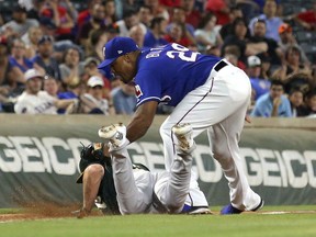 Oakland Athletics' Matt Joyce is picked off at third with a tag by Texas Rangers' Adrian Beltre after fielding a throw from catcher Robinson Chirinos in the seventh inning of a baseball game Tuesday, April 24, 2018, in Arlington, Texas.